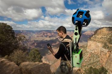 A Google employee, armed with a specialized Street View 360 degree camera, prepares to document the Grand Canyon. Photo Credit: Google.